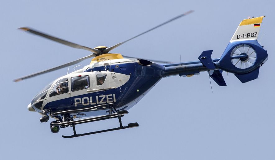 File---File picture taken May 11, 2017 shows a police helicopter flying over the A12 motorway near Briesen, Germany, Police say a 32-year-old Berlin man has been arrested on allegations he had been making radio contact with air traffic, including police helicopters, and given fake flight orders while impersonating an aviation official. (Patrick Pleul/dpa via AP)