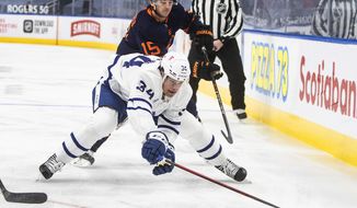 Edmonton Oilers&#39; Josh Archibald (15) chases Toronto Maple Leafs&#39; Auston Matthews (34) during the first period of an NHL hockey game Thursday, Jan. 28, 2021, in Edmonton, Alberta. (Jason Franson/The Canadian Press via AP)