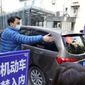 A car that&#39;s part of a convoy carrying the World Health Organization team of researchers arrives at the Hubei Provincial Hospital of Integrated Chinese and Western Medicine also known as the Hubei Province Xinhua Hospital in Wuhan in central China&#39;s Hubei province Friday, Jan. 29, 2021. The World Health Organization team of researchers emerged from their hotel Thursday for the first time since their arrival in the central Chinese city of Wuhan to start searching for clues into the origins of the COVID-19 pandemic. (AP Photo/Ng Han Guan)