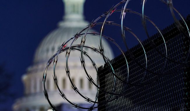 In this Jan. 19, 2021 photo, riot fencing and razor wire reinforce the security zone on Capitol Hill in Washington. The Capitol Police say they are stepping up security at Washington-area transportation hubs and taking other steps to bolster travel security for lawmakers. The moves come as Congress continues to react to this month&#x27;s deadly assault on the Capitol. (AP Photo/J. Scott Applewhite)