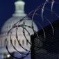 In this Jan. 19, 2021 photo, riot fencing and razor wire reinforce the security zone on Capitol Hill in Washington. The Capitol Police say they are stepping up security at Washington-area transportation hubs and taking other steps to bolster travel security for lawmakers. The moves come as Congress continues to react to this month&#x27;s deadly assault on the Capitol. (AP Photo/J. Scott Applewhite)