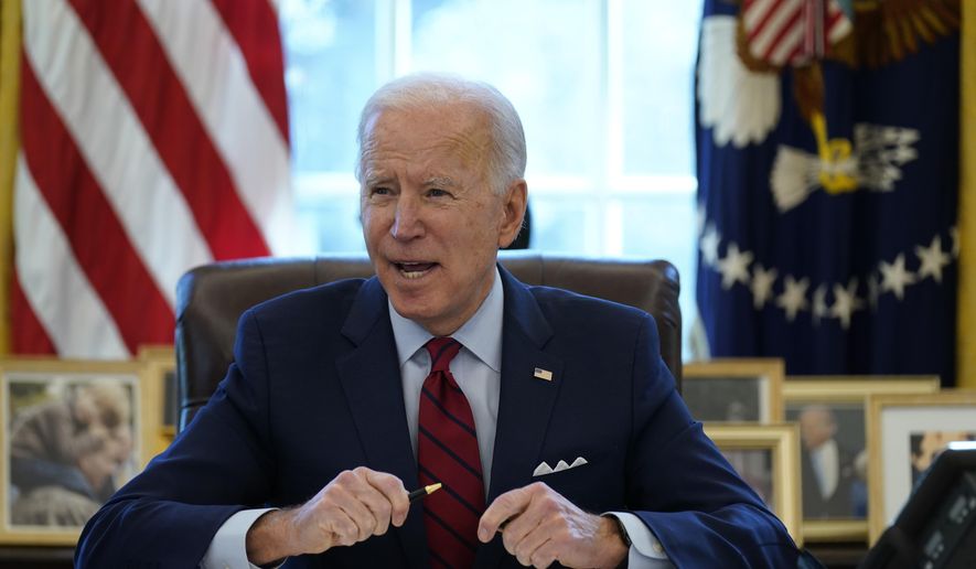 President Joe Biden signs a series of executive orders on health care, in the Oval Office of the White House, Thursday, Jan. 28, 2021, in Washington. The Democratic push to raise the minimum wage to $15 an hour has emerged as an early flashpoint in the push for a $1.9 trillion COVID relief package, providing an early test of President Joe Biden's ability to bridge Washington's partisan divide in pursuing his first major legislative victory. (AP Photo/Evan Vucci) ** FILE **