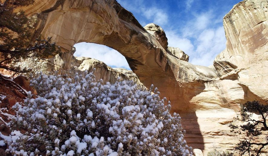 FILE - This undated file photo shows Hickman Arch at Capitol Reef near Torrey, Utah. Capitol Reef National Park has announced its 2021 Artists in Residence program, which pays living expenses for artists to live, work and practice their crafts amid the park's spectacular landscapes. (Danny Chan La/The Salt Lake Tribune via AP, File)