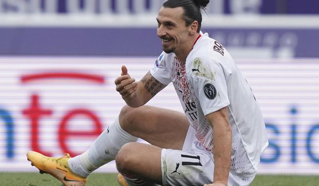 Milan&#x27;s Zlatan Ibrahimovic sits on the grass during the Italian Serie A soccer match between Bologna and Milan at the Renato Dall&#x27;Ara stadium in Bologna, Italy, Saturday, Jan. 30, 2021. (Spada/LaPresse via AP)