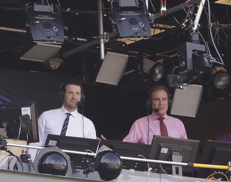 FILE - In this Sept. 24, 2017, file photo, Tony Romo and Jim Nantz work in the broadcast booth before an NFL football game between the Green Bay Packers and the Cincinnati Bengals in Green Bay, Wis.  Nantz and Romo were inseparable when CBS broadcast the Super Bowl two years ago. Next week, they won&#39;t see each other until they are in the broadcast booth a couple hours prior to kickoff. Keeping announcers separated until game day has been standard practice this season due to the Coronavirus pandemic. (AP Photo/Morry Gash, File)