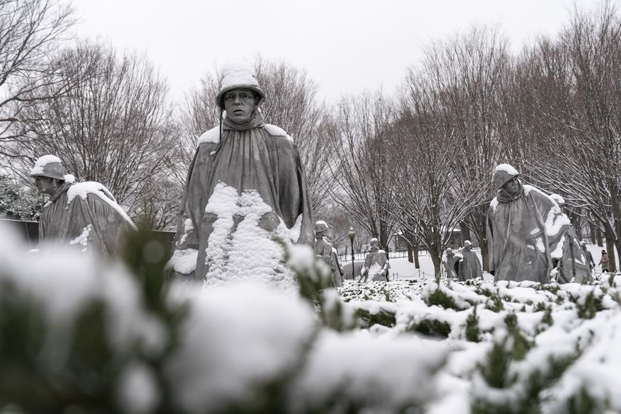 Snow blankets the soldiers at the Korean War Veterans Memorial, Sunday, Jan. 31, 2021, in Washington. (AP Photo/Alex Brandon)