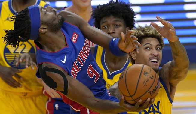 Detroit Pistons forward Jerami Grant (9) shoots against Golden State Warriors center James Wiseman, middle, and guard Kelly Oubre Jr. during the first half of an NBA basketball game in San Francisco, Saturday, Jan. 30, 2021. (AP Photo/Jeff Chiu)