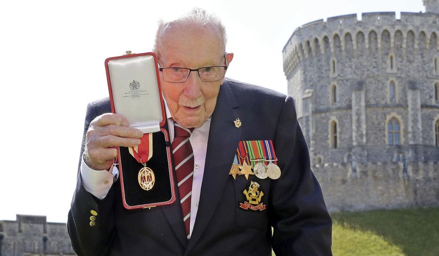 FILE - In this Friday, July 17, 2020 file photo, Captain Sir Thomas Moore poses for the media after receiving his knighthood from Britain's Queen Elizabeth, during a ceremony at Windsor Castle in Windsor, England. Tom Moore, the 100-year-old World War II veteran who captivated the British public in the early days of the coronavirus pandemic with his fundraising efforts, has been admitted to a hospital with COVID-19, his daughter said Sunday Jan. 31, 2021. (Chris Jackson/Pool Photo via AP, File)