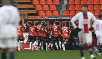 Lorient&#39;s players celebrate their side&#39;s third goal during the French League One soccer match between FC Lorient and Paris Saint-Germain at the Moustoir stadium in Lorient, western France, Sunday, Jan. 31, 2021. (AP Photo/David Vincent)