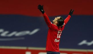 Lille&#x27;s Yusuf Yazici celebrates his side&#x27;s first goal during the French League One soccer match between Lille and Dijon at the Stade Pierre Mauroy stadium in Villeneuve d&#x27;Ascq, northern France, Sunday, Jan. 31, 2021. (AP Photo/Michel Spingler)
