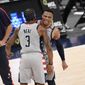 Washington Wizards guard Russell Westbrook, back, reacts with guard Bradley Beal (3) after he made a three-point basket during the second half of an NBA basketball game against the Brooklyn Nets, Sunday, Jan. 31, 2021, in Washington. (AP Photo/Nick Wass)
