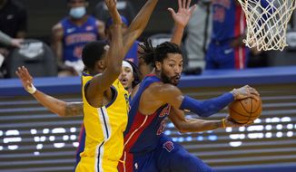 Detroit Pistons guard Derrick Rose, right, passes the ball while defended by Golden State Warriors forward Andrew Wiggins during the first half of an NBA basketball game in San Francisco, Saturday, Jan. 30, 2021. (AP Photo/Jeff Chiu)