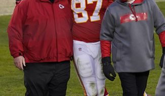 FILE - In this Jan. 17, 2021, file photo, Kansas City Chiefs tight end Travis Kelce (87) walks off the field with coach Andy Reid after an NFL divisional round football game against the Cleveland Browns in Kansas City, Mo. Both Reid and Bruce Arians are considered players’ coaches, though they do it in different ways. It&#39;s a quality that’s helped them reach the Super Bowl. (AP Photo/Orlin Wagner, File)