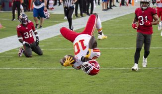 In this Nov. 29, 2020 file photo, Kansas City Chiefs wide receiver Tyreek Hill (10) does a back flip into the end zone to score a touchdown against the Tampa Bay Buccaneers during an NFL football game in Tampa, Fla. Hill was unstoppable against Tampa Bay in late November. The speedy Kansas City star caught 13 passes for 269 yards and three touchdowns in the Chiefs&#39; 27-24 victory that afternoon. Tampa Bay gets another shot at Hill and the Chiefs in the Super Bowl on Sunday, Feb. 7, 2021. (AP Photo/Doug Murray, File) **FILE**