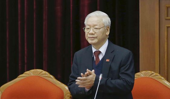 In this file photo, Vietnam Communist party General Secretary Nguyen Phu Trong applauds during a party meeting in Hanoi, Vietnam, Sunday, Jan. 31, 2021.  (Le Tri Dung/VNA via AP)  **FILE**