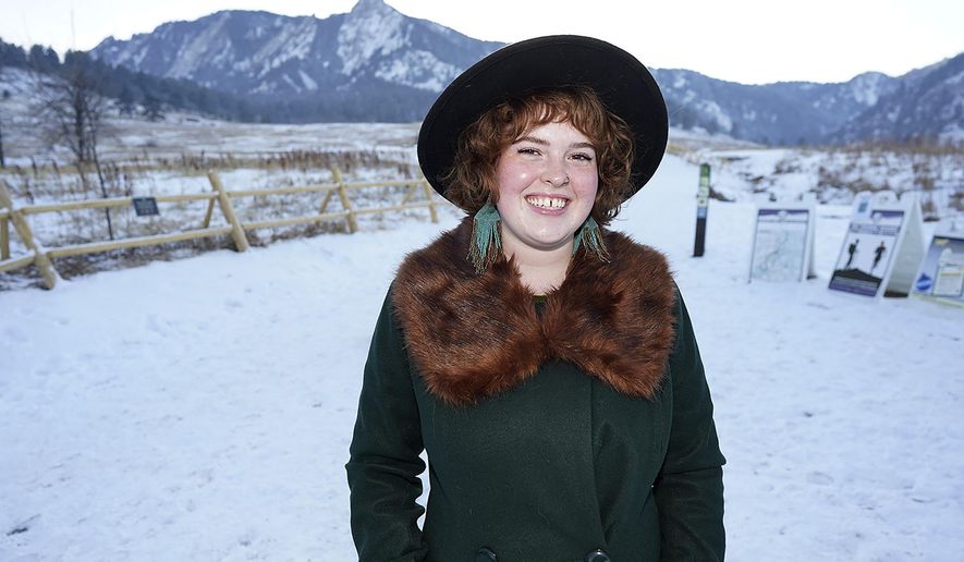 Bryleigh McCarty is shown in Chautauqua Park late Wednesday, Jan. 27, 2021, in Boulder, Colo. The 21-year-old, who has recovered from a case of a COVID-19, is working at a local school after losing her previous job—managing a yarn store—because of the effects on the economy because of the spread of the virus last year. (AP Photo/David Zalubowski)