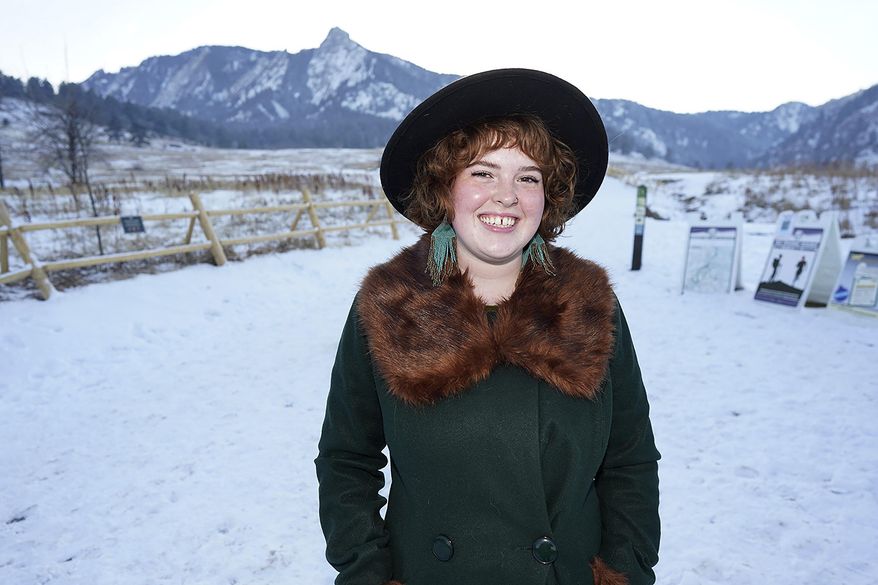 Bryleigh McCarty is shown in Chautauqua Park late Wednesday, Jan. 27, 2021, in Boulder, Colo. The 21-year-old, who has recovered from a case of a COVID-19, is working at a local school after losing her previous job—managing a yarn store—because of the effects on the economy because of the spread of the virus last year. (AP Photo/David Zalubowski)