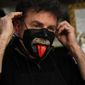 Venetian artisan carnival mask maker Gualtiero Dall&#39;Osto wears one of his creations in his workshop in Venice, Italy, Saturday, Jan. 30, 2021. (AP Photo/Antonio Calanni)
