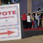 In this Nov. 3, 2020, file photo, people wait in line to vote at a polling place on Election Day in Las Vegas. (AP Photo/John Locher, File)  **FILE**