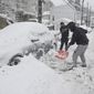 Frank White, of Fort Lauderdale, Florida, front, and Devine Marks, of Pottsville, Pa., shovel out a car on E. Norwegian Street in Pottsville, Pa., on Monday, Feb. 1, 2021. (Jacqueline Dormer/Republican-Herald via AP)
