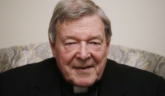 FILE - In this Nov. 30,  2020, file photo, Cardinal George Pell poses for a picture during an interview with the Associated Press inside his residence near the Vatican in Rome. Australian media companies admitted in court Monday, Feb. 1, 2021, they breached a gag order in publishing references to Cardinal George Pell’s since-overturned convictions in 2018 for child sexual abuse. The plea agreement avoids any journalist being sent to prison.(AP Photo/Gregorio Borgia, File)