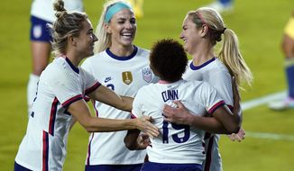 U.S. midfielder Lindsey Horan, right, is congratulated, after scoring a goal against Colombia, by midfielder Kristie Mewis, left, midfielder Julie Ertz, center, and defender Crystal Dunn, second from right, during the second half of an international friendly soccer match Friday, Jan. 22, 2021, in Orlando, Fla. (AP Photo/John Raoux)