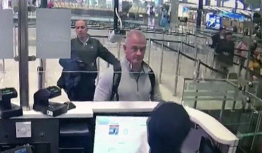 FILE—This Dec. 30, 2019 image from security camera video shows Michael L. Taylor, center, and George-Antoine Zayek at passport control at Istanbul Airport in Turkey. Taylor is accused of smuggling former Nissan Motor Co. Chairman Carlos Ghosn out of Japan in 2019 while he was awaiting trial on financial misconduct charges. (DHA via AP, File)
