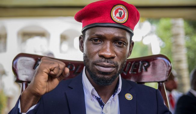 Opposition presidential challenger Bobi Wine, whose real name is Kyagulanyi Ssentamu, gestures as he speaks to the media outside his house, in Magere, near Kampala, in Uganda Tuesday, Jan. 26, 2021. An attorney for Bobi Wine says Ugandan soldiers have withdrawn from the opposition presidential challenger’s home the day after a judge ruled that his house arrest was unlawful. But the attorney tells The Associated Press that security forces can still be seen in the village near the candidate’s property outside the capital, Kampala.  (AP Photo/Nicholas Bamulanzeki)