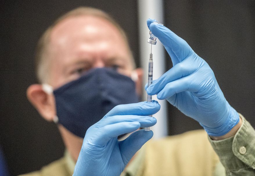 Pharmacist Kevin Corbin fills a syringe with the COVID-19 vaccine during the COVID-19 vaccination clinic at Warren Baptist Church in Augusta, Ga., Thursday, Jan. 28, 2021. (Michael Holahan/The Augusta Chronicle via AP)