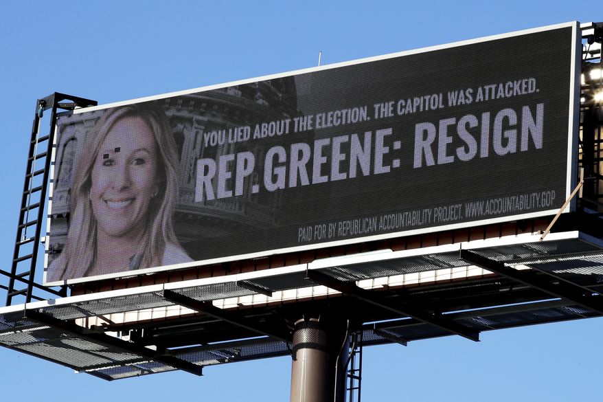 A billboard calls in Dalton, Georgia, for the resignation of Rep. Marjorie Taylor Greene. The U.S. House will likely vote Thursday to strip her of her committee assignments. (AP Photo/Ben Margot)