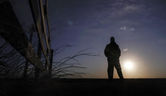 Lateef Dowdell watches the sunrise from what remains of land once belonging to his uncle Gil Alexander, who was the last active Black farmer in the community of Nicodemus, Kan., Thursday, Jan. 14, 2021. Dowdell moved back to Nicodemus, a settlement founded by former slaves known as &amp;quot;exodusters&amp;quot; in the 1870s, several years earlier to take over the farm after his uncle died, but soon after lost most of the land when the bank foreclosed. New legislation in Congress aims to remedy historical inequities in government farm programs that have helped reduce the number of Black farmers in the United States from about a million in 1920 to less than 50,000 today. (AP Photo/Charlie Riedel)
