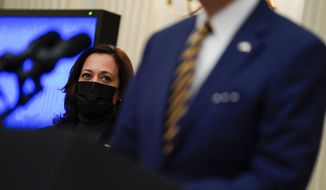 FILE - In this Jan. 22, 2021, file photo Vice President Kamala Harris listens as President Joe Biden delivers remarks on the economy in the State Dining Room of the White House in Washington. (AP Photo/Evan Vucci, File)