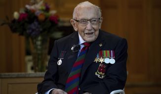 In this Sept. 24, 2020, file photo, Captain Sir Tom Moore in Marston Moretaine, England, attends the launch event for the Lloyd Scott Three Peaks Challenge. Tom Moore, the 100-year-old World War II veteran who captivated the British public in the early days of the coronavirus pandemic with his fundraising efforts, has died, Tuesday Feb. 2, 2021. (Jacob King/PA via AP, File)