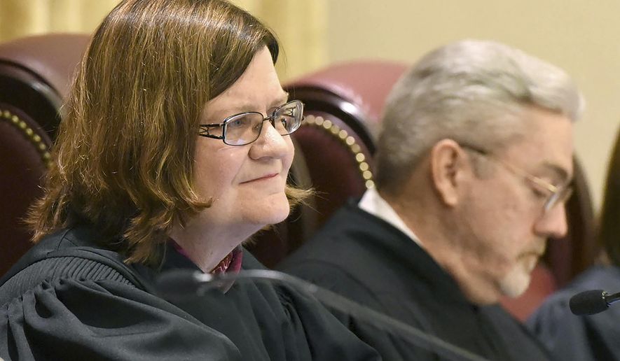 FILE - In this Feb. 24, 2016 file photo, Missouri Supreme Court Judge Laura Denvir Stith, left, sits on the bench at the Missouri Supreme Court building in Jefferson City, Mo. Stith is retiring. Stith on Tuesday, Feb. 2, 2021, said her last day will be March 8. She was appointed to the state Supreme Court in 2001 by former Democratic Gov. Bob Holden. She was the second woman appointed to the state high court. (Annie Rice/Missourian via AP, File)