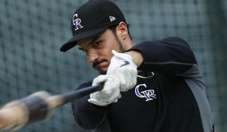 FILE - In this Friday, Sept. 27, 2019, file photo, Colorado Rockies third baseman Nolan Arenado warms up before a baseball game against the Milwaukee Brewers in Denver. Team owner Dick Monfort and general manager Jeff Bridich will hold a zoom press conference Tuesday, Feb. 2, 2021, to discuss the trade of the team&#39;s star third baseman, Nolan Arenado, to the St. Louis Cardinals. (AP Photo/David Zalubowski, File)