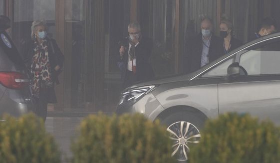 Members of a World Health Organization team leave their hotel on a foggy day for another day of field visit in Wuhan in central China&#39;s Hubei province on Wednesday, Feb. 3, 2021. The WHO team is investigating the origins of the coronavirus pandemic has visited two disease control centers in the province. (AP Photo/Ng Han Guan)