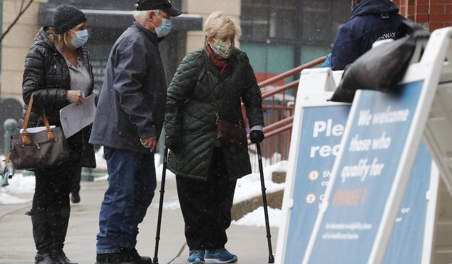 People arrive at a COVID-19 vaccination site at Fenway Park, Tuesday, Feb. 2, 2021, in Boston. (AP Photo/Michael Dwyer)