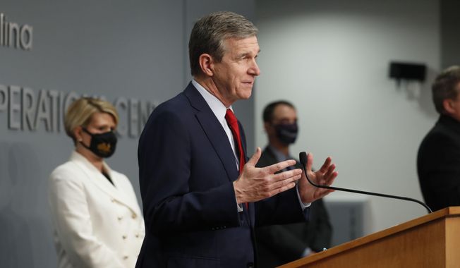 N.C. Gov. Roy Cooper speaks during a briefing at the Emergency Operations Center in Raleigh, N.C., Tuesday, Feb.  2, 2021.  Cooper says would like to see all 115 school districts in the state allow students to return to physical classrooms. But he says he does not support a bill from Republican state lawmakers that would do just that.  ((Ethan Hyman/The News &amp;amp; Observer via AP)