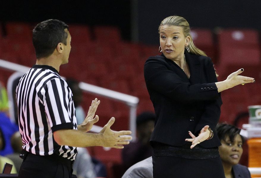 FILE - In this Monday, Dec. 9, 2013, file photo, Siena head coach Ali Jaques, right, speaks with an official in the second half of an NCAA college basketball game against Maryland in College Park, Md. Siena will play for the first time in nearly a month on Wednesday, Feb. 3, 2021, at Monmouth, with just six available players. (AP Photo/Patrick Semansky, File)