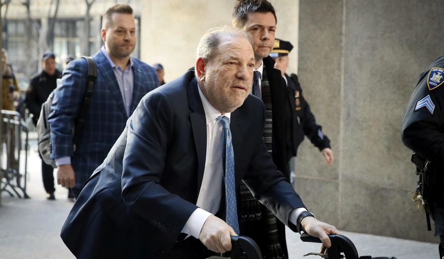 In this Feb. 24, 2020, file photo, Harvey Weinstein arrives at a Manhattan courthouse as jury deliberations continue in his rape trial in New York. A Delaware judge has approved a revised Weinstein Co. bankruptcy plan that provides about $35 million for creditors, with roughly half that amount going to women who&#39;ve accused Weinstein of sexual misconduct. The judge approved the plan following a hearing and overruled objections by attorneys representing four women. (AP Photo/John Minchillo, File)