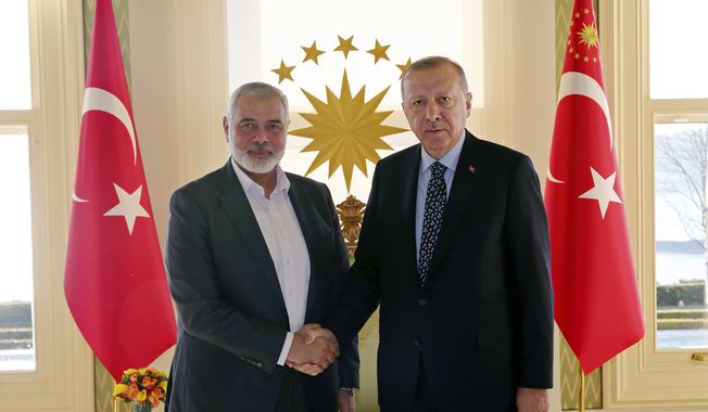 In this Feb. 1, 2020, file photo, Turkey&#x27;s President Recep Tayyip Erdogan, right, shakes hands with Hamas movement chief Ismail Haniyeh, prior to their meeting in Istanbul. (Presidential Press Service via AP, Pool, File)