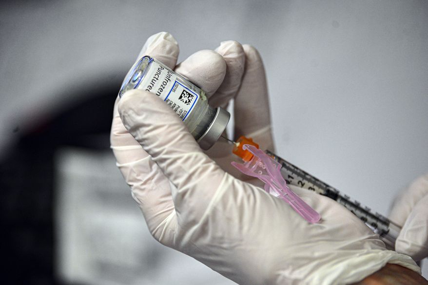 Sharon Gordon, a registered nurse at Brattleboro Memorial Hospital draws up the Moderna COVID-19 vaccine into a syringe as the hospital held a COVID-19 vaccination clinic for people 75 years old and up on Wednesday, Feb. 3, 2021, in Brattleboro, Vt. (Kristopher Radder/The Brattleboro Reformer via AP) **FILE**