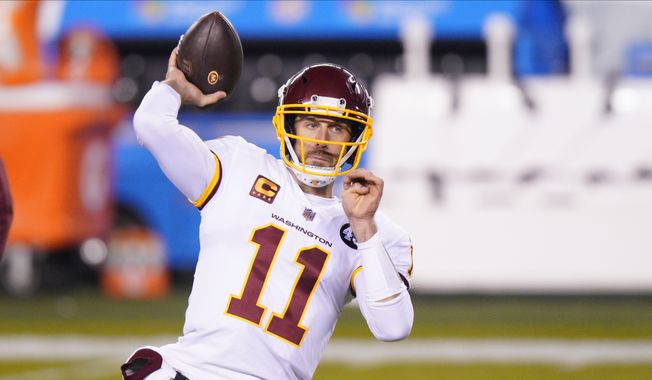Washington Football Team quarterback Alex Smith warms up before an NFL football game against the Philadelphia Eagles in Philadelphia, in this Sunday, Jan. 3, 2021, file photo. Washingtons biggest offseason need is to figure out its quarterback situation. Trade for DeShaun Watson? Sign Cam Newton? Roll with Alex Smith and Kyle Allen? Coach Ron Rivera says nothing is off the table. (AP Photo/Chris Szagola, File) **FILE**