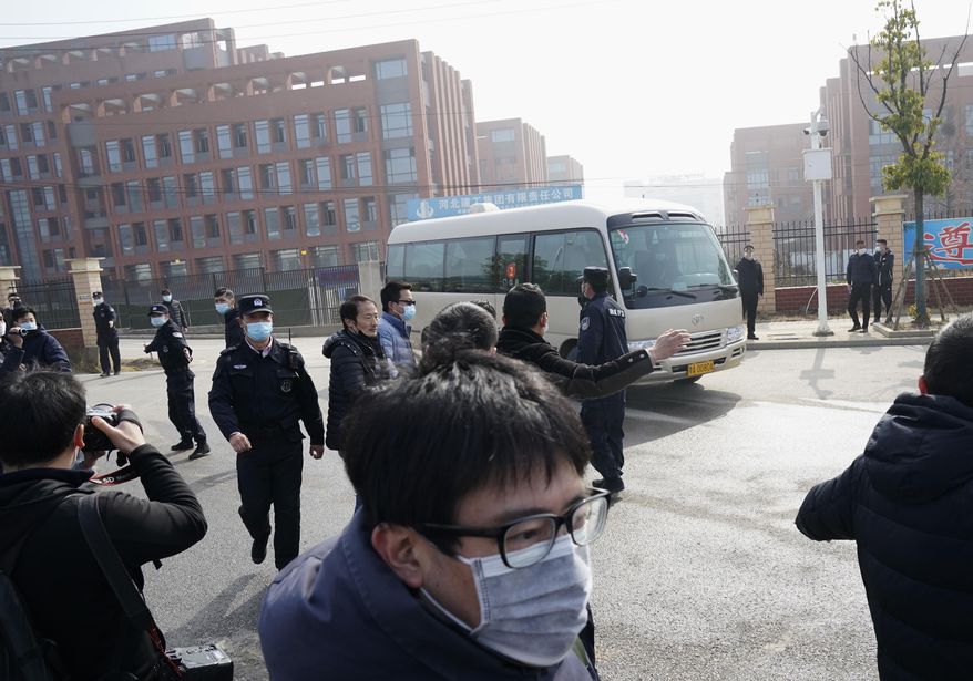 Journalists and security personnel gather near the entrance of the Wuhan Institute of Virology after a visit by the World Health Organization team in Wuhan in China&#39;s Hubei province on Wednesday, Feb. 3, 2021. (AP Photo/Ng Han Guan)