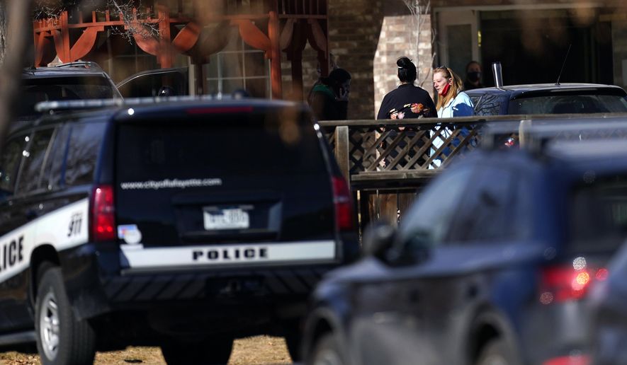Employees gather outside the Legacy Assisted Living in Lafayette care facility, Wednesday, Feb. 3, 2021, in Lafayette, Colo. A 95-year-old resident of the assisted care home was taken into police custody Wednesday after allegedly shooting an employee at the center. (AP Photo/David Zalubowski)