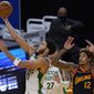 Boston Celtics forward Jayson Tatum, left, shoots next to Golden State Warriors guard Kelly Oubre Jr. (12) during the first half of an NBA basketball game in San Francisco, Tuesday, Feb. 2, 2021. (AP Photo/Jeff Chiu)