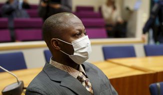 Sierra Leonean national Gibril Massaquoi, 51, wears a face mask as he attends his trial at the Pirkanmaa District Court in Tampere, Finland, Wednesday Feb. 3, 2021, accused of committing war crimes during Liberia&#39;s second civil war two decades ago.  Massaquoi faces several charges including dozens of murders, eight rapes as well as aggravated war crimes and aggravated human rights violations during Liberia&#39;s 1999-2003 war. (Kalle Parkkinen/Lehtikuva via AP)