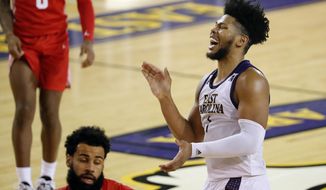 East Carolina&#39;s Jayden Gardner (1) starts to celebrate during the closing minutes of the second half of an NCAA college basketball game against Houston in Greenville, N.C., Wednesday, Feb. 3, 2021. (AP Photo/Karl B DeBlaker)