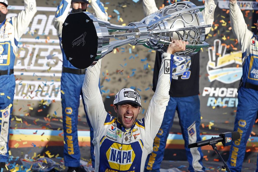 Chase Elliott holds up the season championship trophy as he celebrates with his race crew in Victory Lane after winning the NASCAR Cup Series auto race at Phoenix Raceway in Avondale, Ariz., in this Sunday, Nov. 8, 2020, file photo. NASCAR is being heavily promoted by a broadcast partner as about to embark on “The Best Season Ever” and on paper that could be true. NASCAR this year will race on dirt for the first time since 1970, the schedule includes a whopping seven road courses and five venues new to the Cup Series. Michael Jordan and Pitbull are among new team owners entering the sport in 2021 and Chase Elliott, NASCAR’s most popular driver, is the reigning champion. (AP Photo/Ralph Freso, File) **FILE**