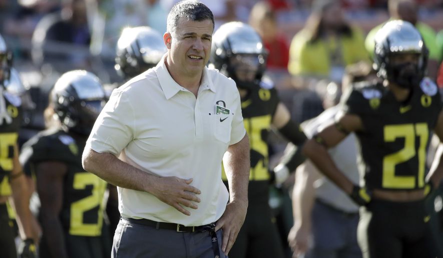FILE - Oregon head coach Mario Cristobal watches during warm ups before the Rose Bowl NCAA college football game against Wisconsin, in Pasadena, Calif., in this Wednesday, Jan. 1, 2020, file photo. The National Signing Day period begins Wednesday, Feb. 3, 2021. (AP Photo/Marcio Jose Sanchez, File)